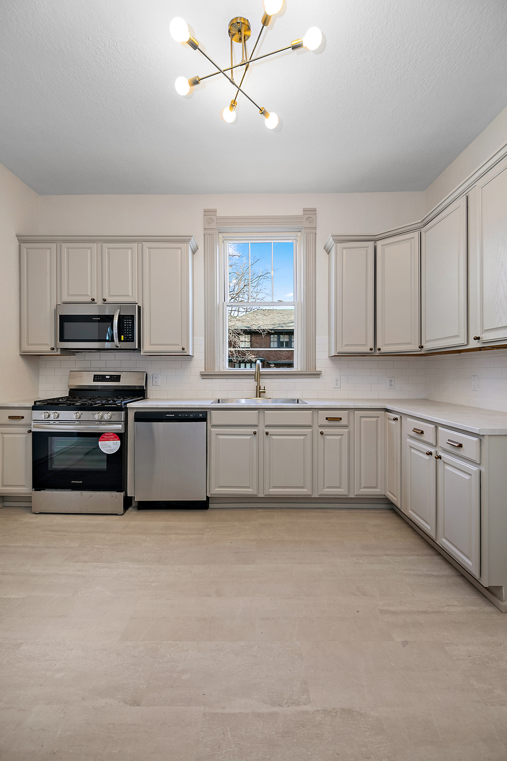 505 South Indiana Avenue Kankakee, IL 60901 - Photo 11 of 32 a kitchen with cabinets a window and stainless steel appliances
