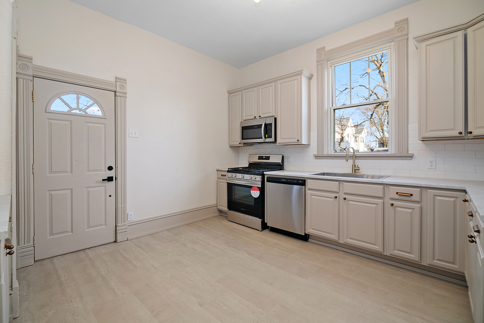 505 South Indiana Avenue Kankakee, IL 60901 - Photo 13 of 32 a kitchen with granite countertop a stove a sink and a window