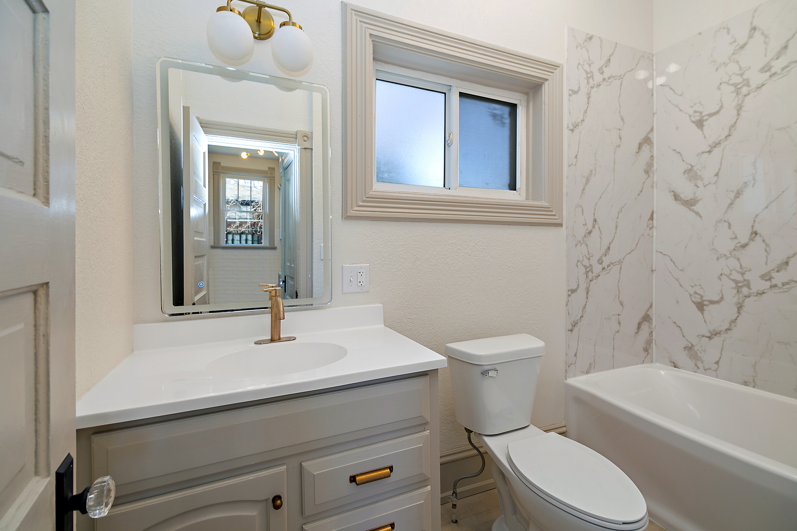 505 South Indiana Avenue Kankakee, IL 60901 - Photo 17 of 32 a bathroom with a sink a toilet and shower