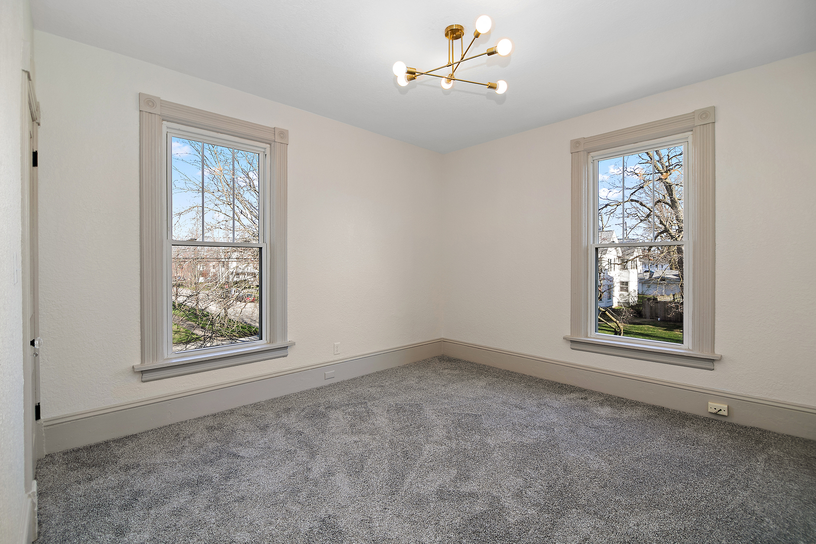 505 South Indiana Avenue Kankakee, IL 60901 - Photo 20 of 32 an empty room with windows and ceiling fan