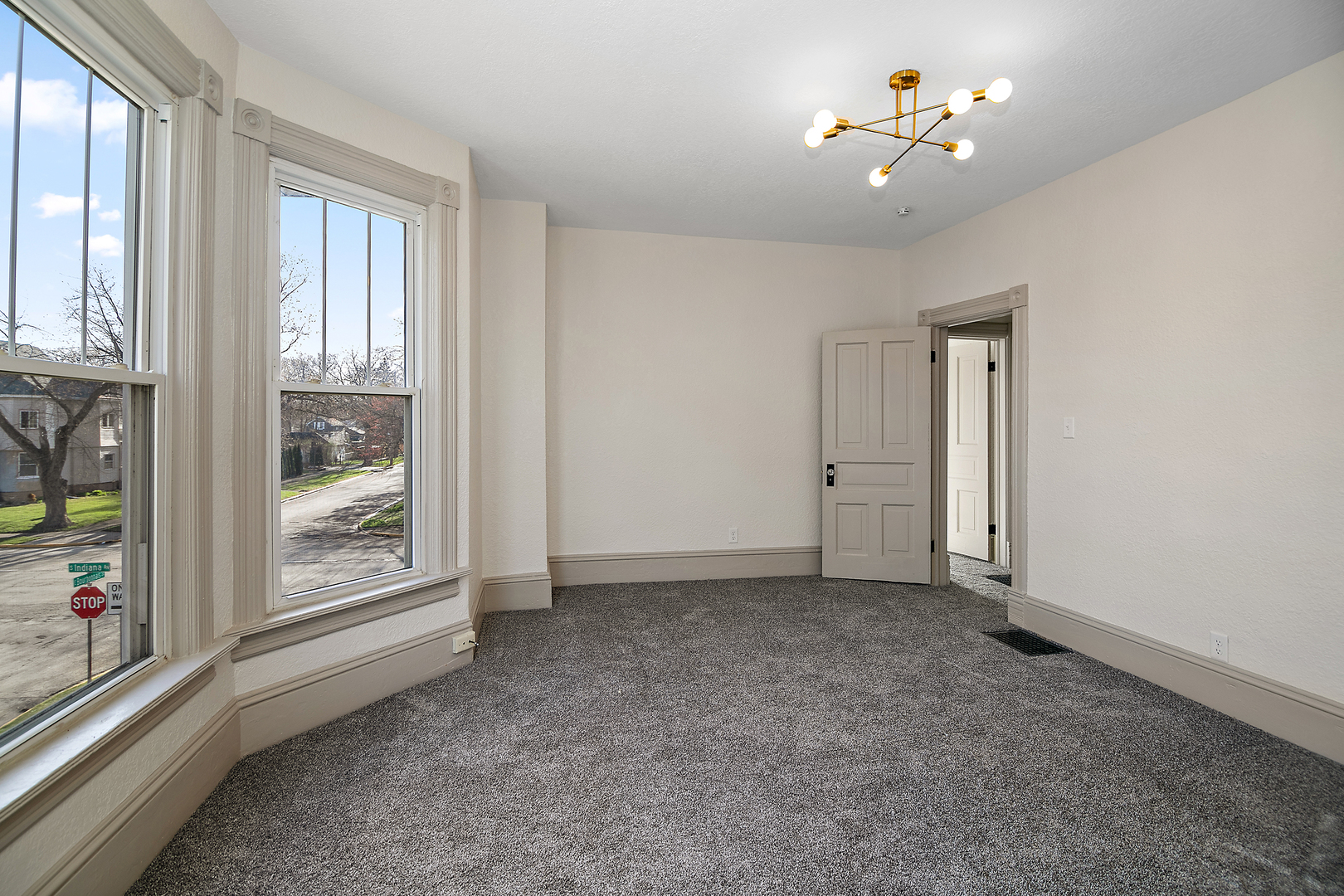 505 South Indiana Avenue Kankakee, IL 60901 - Photo 25 of 32 an empty room with windows and ceiling fan