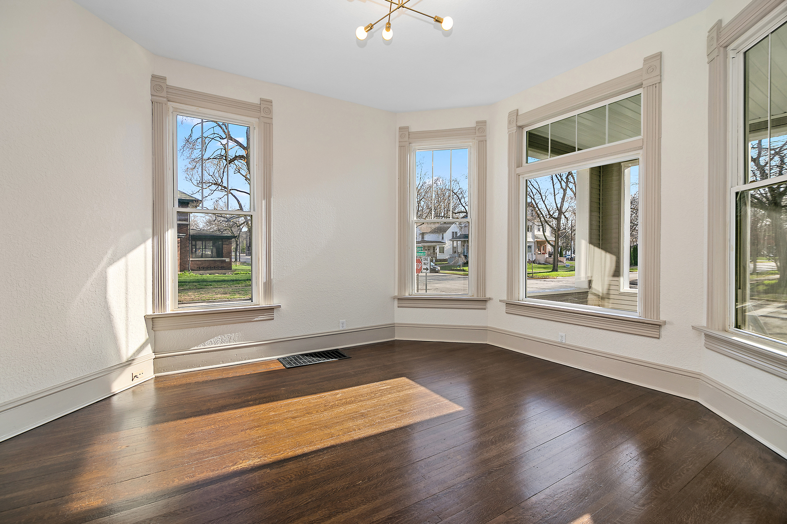 505 South Indiana Avenue Kankakee, IL 60901 - Photo 5 of 32 a view of an empty room with wooden floor and a window