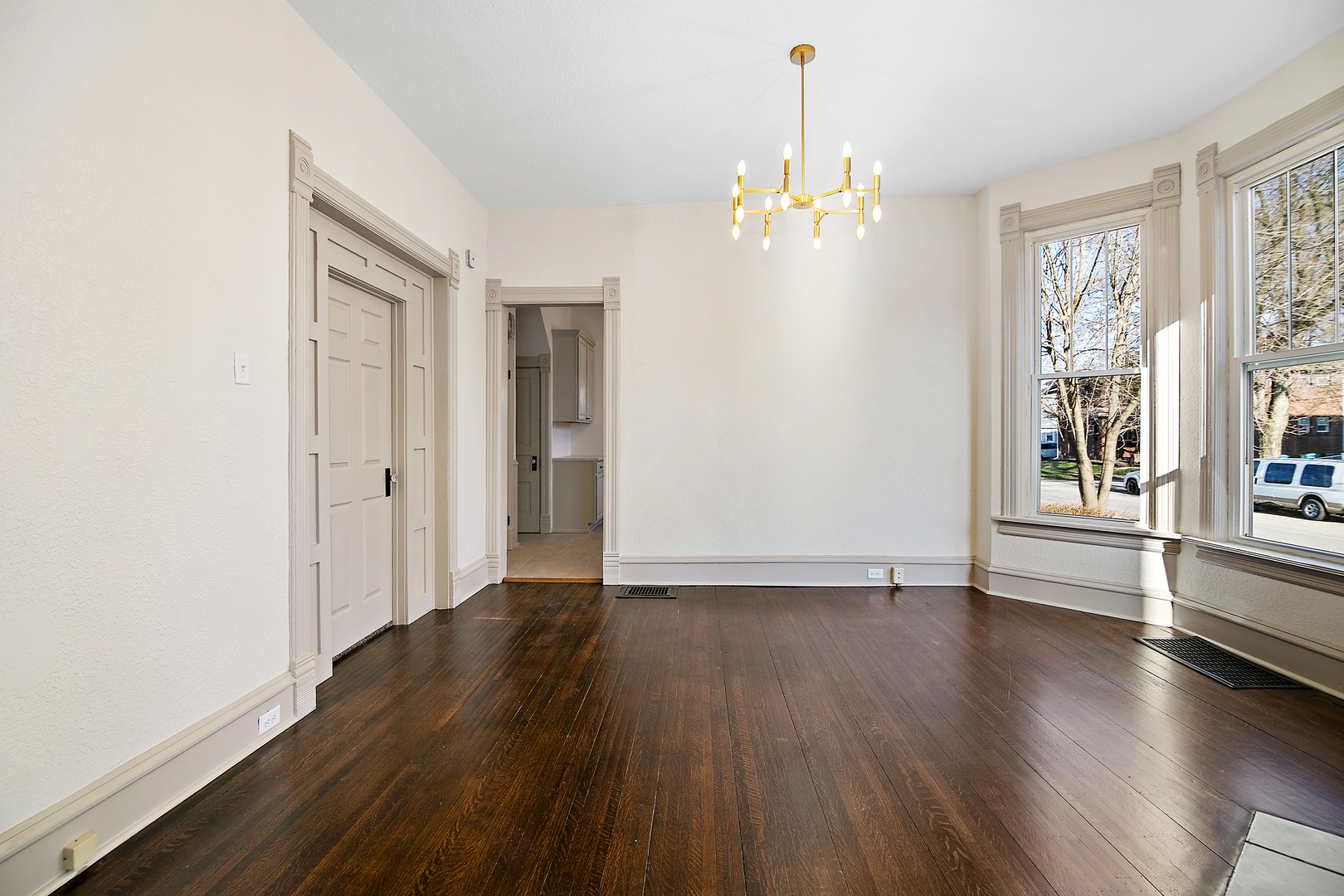 505 South Indiana Avenue Kankakee, IL 60901 - Photo 8 of 32 an empty room with wooden floor and windows