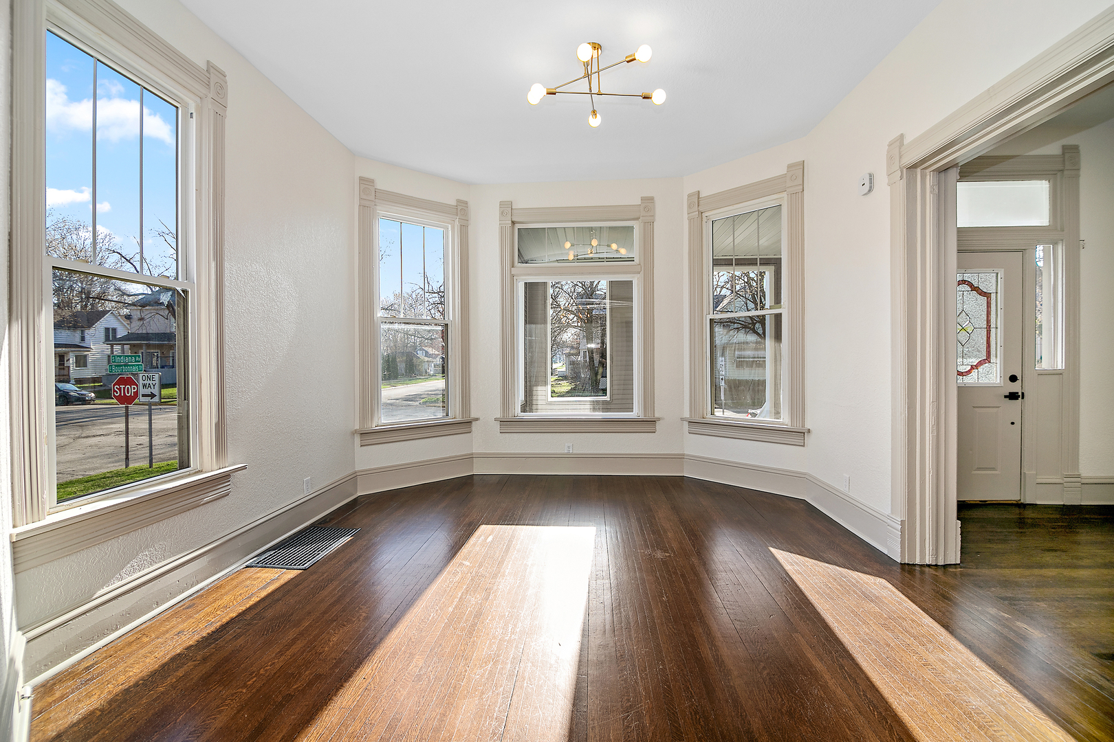 505 South Indiana Avenue Kankakee, IL 60901 - Photo 9 of 32 a view of an empty room with wooden floor and a window