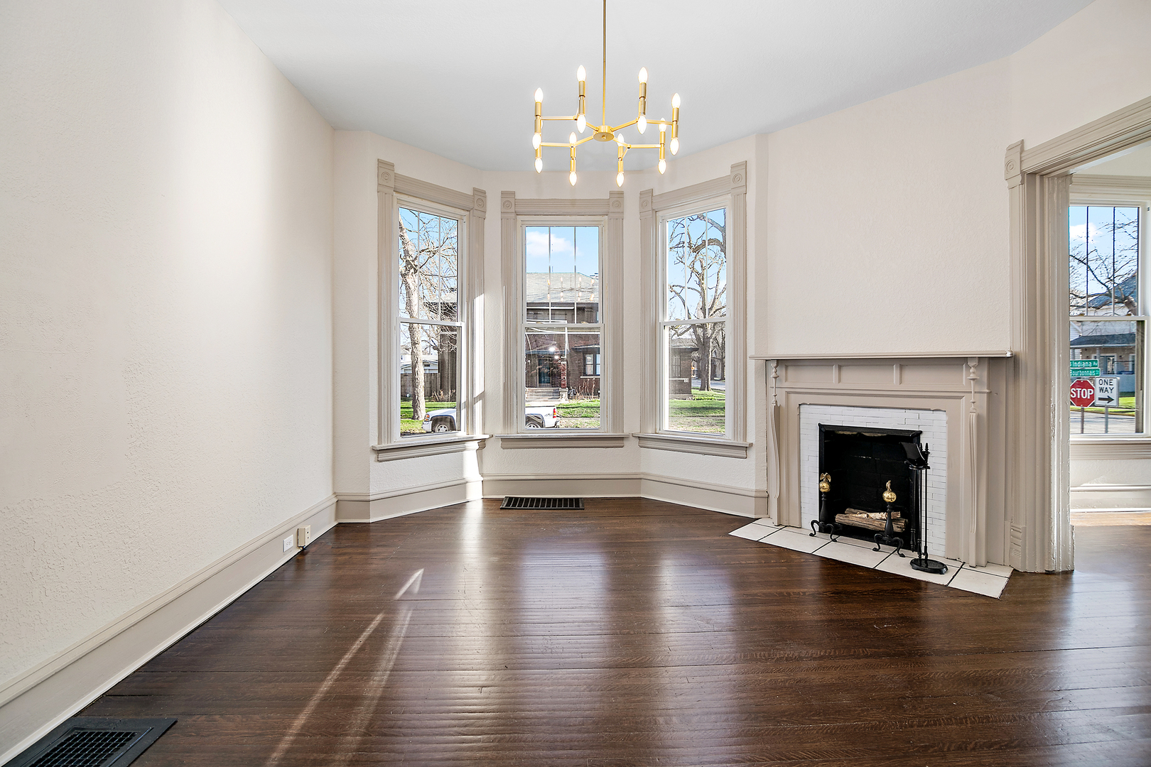 505 South Indiana Avenue Kankakee, IL 60901 - Photo 10 of 32 a view of an empty room with wooden floor fireplace and a window