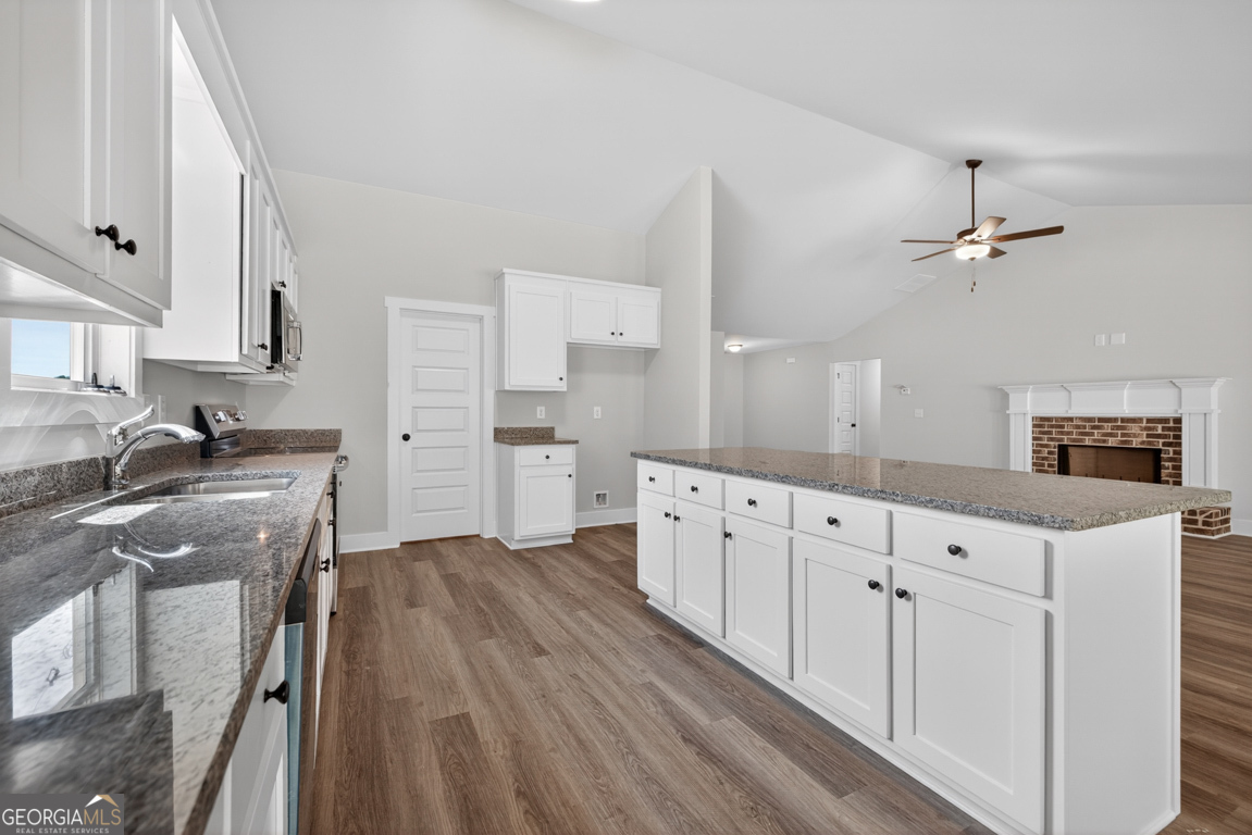 206 Airport Road, Unit 11 Canon, GA 30520 - Photo 13 of 34 a kitchen with granite countertop a sink cabinets stainless steel appliances and a counter space
