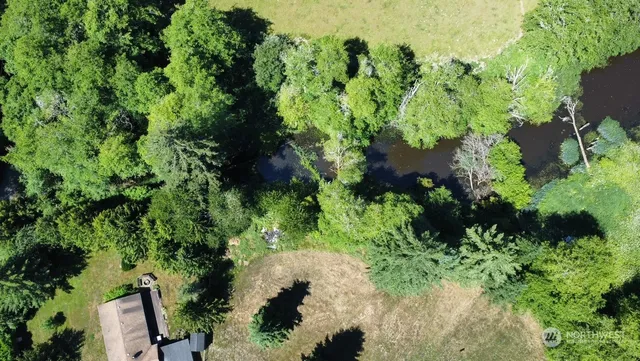 an aerial view of a house with a yard