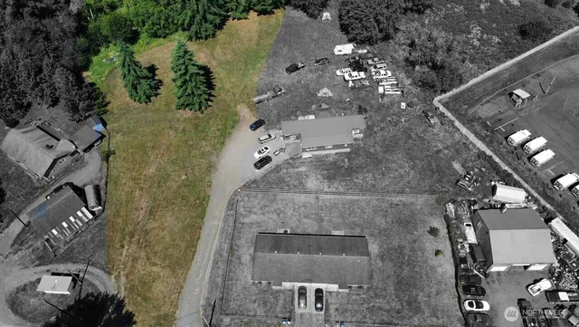 an aerial view of a residential houses with outdoor space