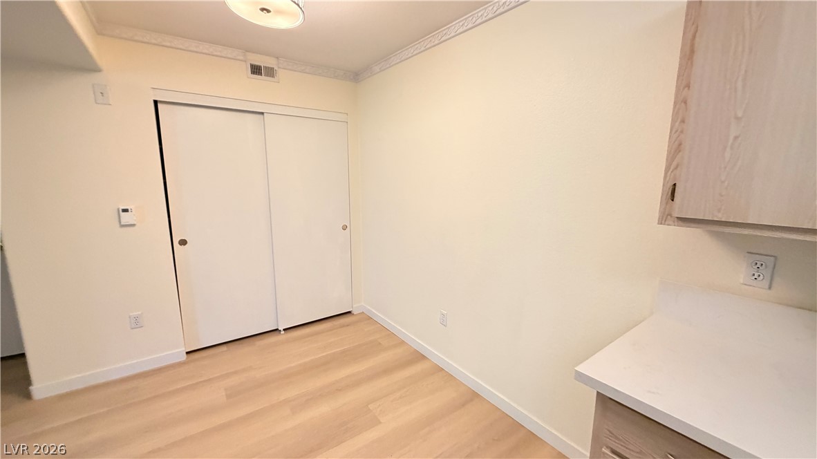 7885 West Flamingo Road, Unit 1131 Las Vegas, NV 89147 - Photo 22 of 36 Functional area with streamlined cabinetry and wood-like flooring.