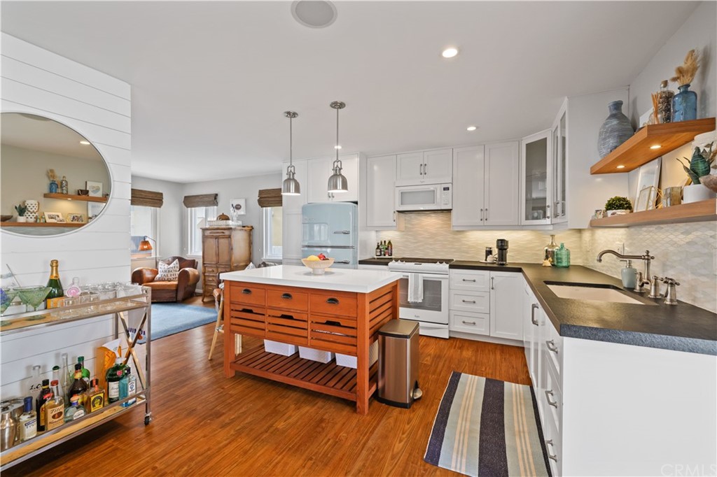 C-29 Surfside Avenue Surfside, CA 90743 - Photo 13 of 36 a large kitchen with stainless steel appliances granite countertop a lot of counter space and wooden floors