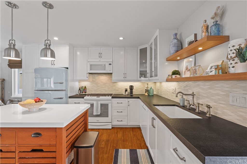 C-29 Surfside Avenue Surfside, CA 90743 - Photo 14 of 36 a kitchen with a sink stove and cabinets