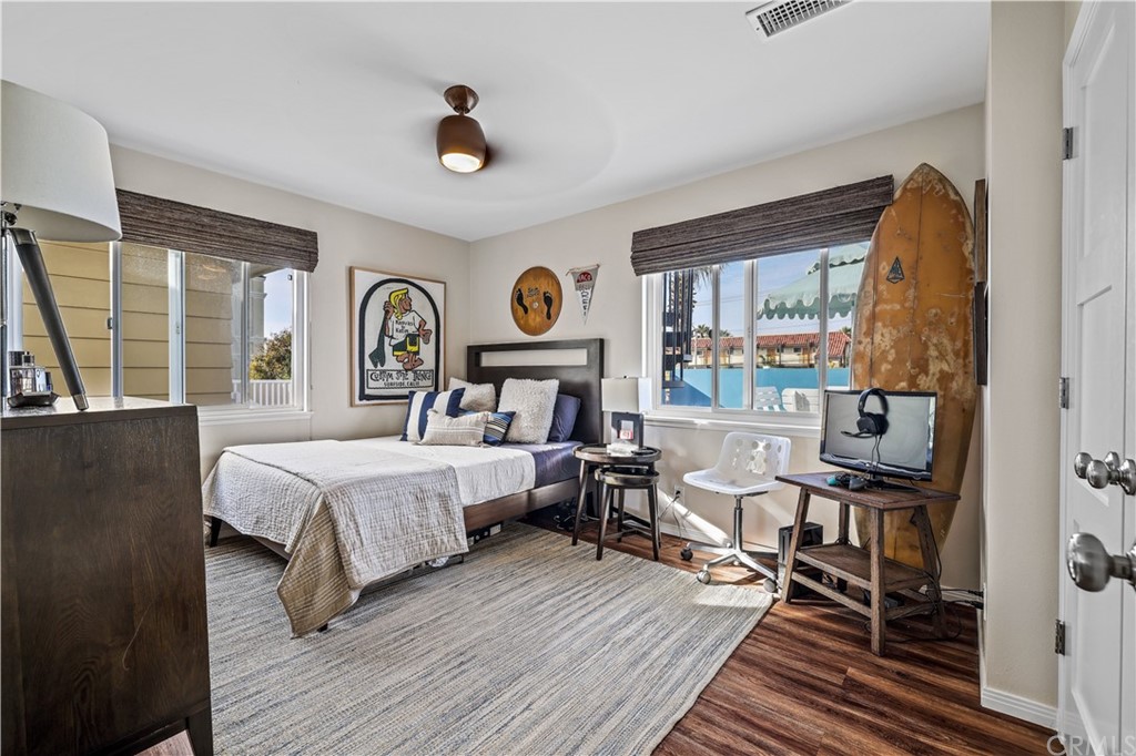 C-29 Surfside Avenue Surfside, CA 90743 - Photo 31 of 36 a bedroom with a bed and wooden floor