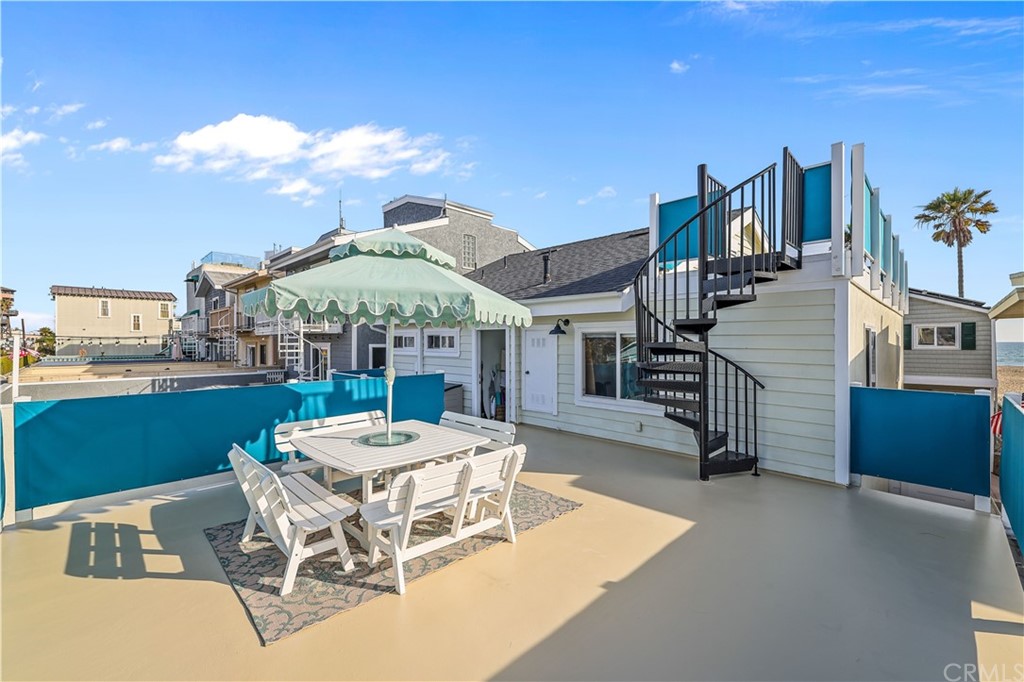 C-29 Surfside Avenue Surfside, CA 90743 - Photo 32 of 36 a view of a patio with a table and chairs