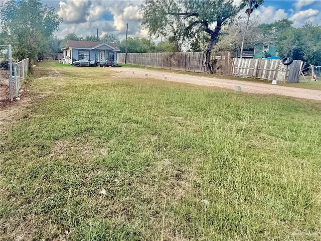 a view of swimming pool with a bench and trees around