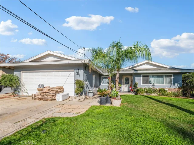 a front view of a house with a garden and patio