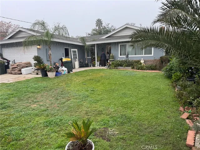 a view of a house with backyard porch and sitting area