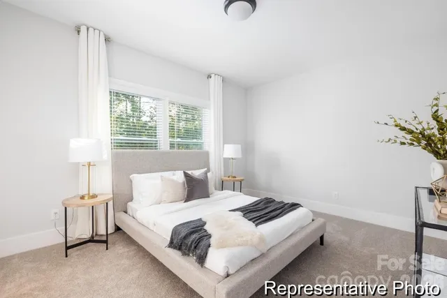 a bedroom with a bed and a night stand