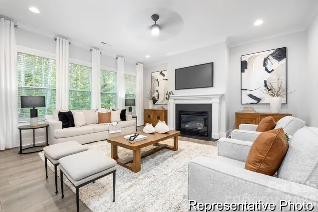 a living room with furniture fireplace and window