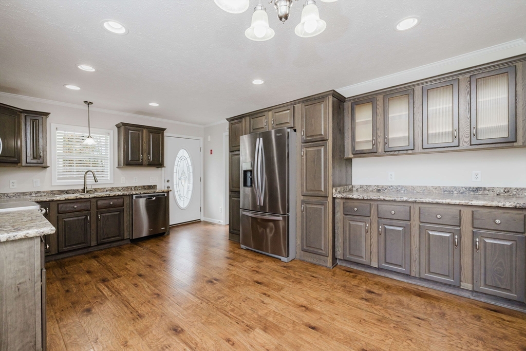 17 Maries Way Raynham, MA 02767 - Photo 12 of 39 a open kitchen with stainless steel appliances granite countertop a stove refrigerator and cabinets
