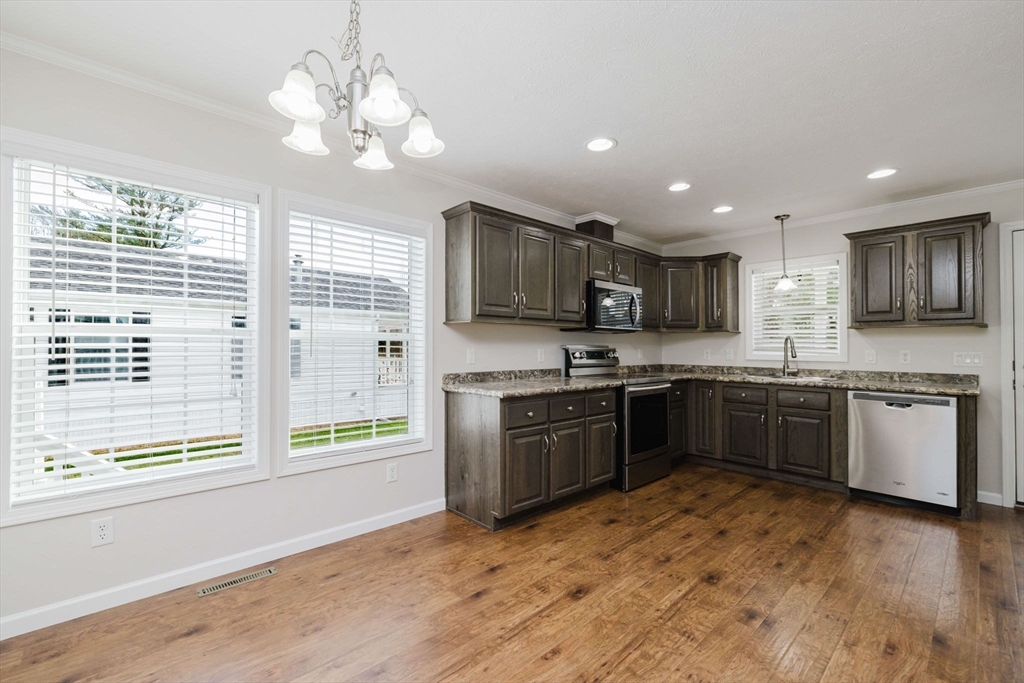 17 Maries Way Raynham, MA 02767 - Photo 13 of 39 a large kitchen with stainless steel appliances granite countertop a stove sink and cabinets