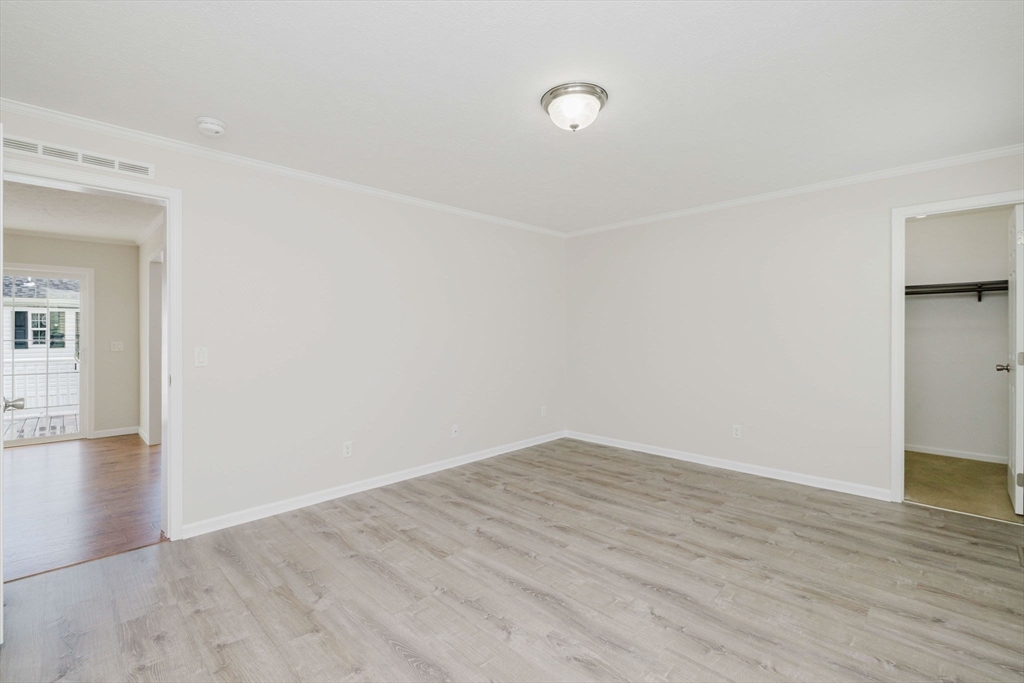 17 Maries Way Raynham, MA 02767 - Photo 21 of 39 a view of an empty room with wooden floor and a window