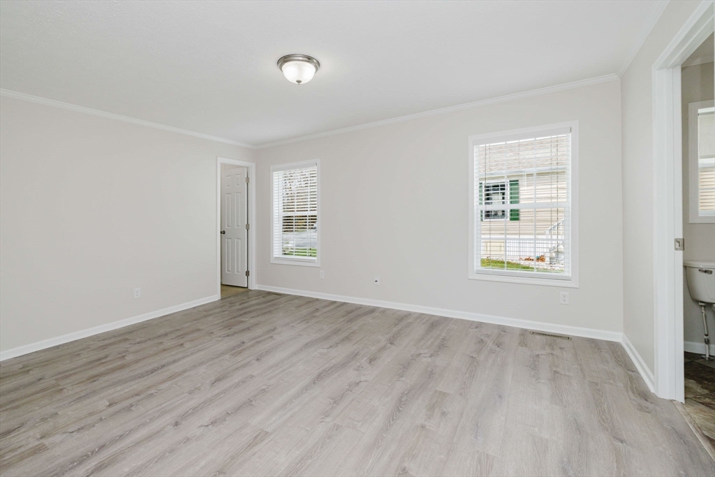 17 Maries Way Raynham, MA 02767 - Photo 22 of 39 an empty room with wooden floor and windows