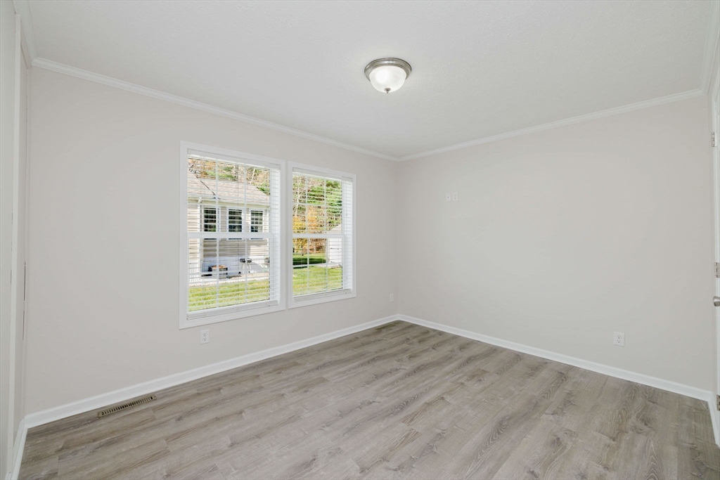 17 Maries Way Raynham, MA 02767 - Photo 23 of 39 an empty room with wooden floor and windows