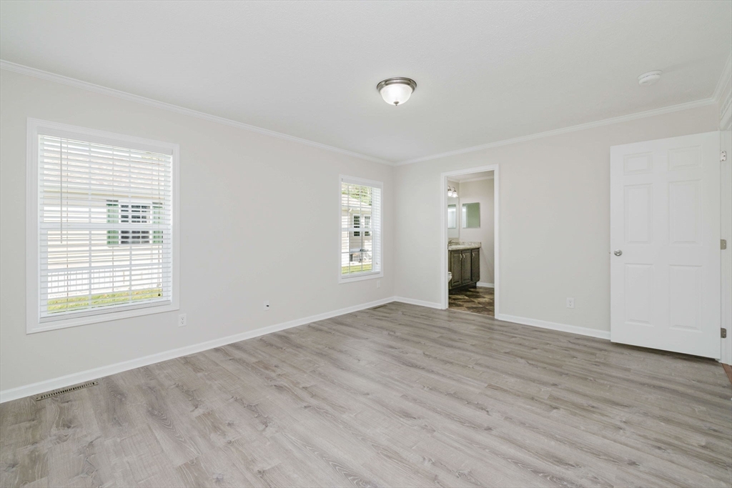 17 Maries Way Raynham, MA 02767 - Photo 24 of 39 an empty room with wooden floor and windows
