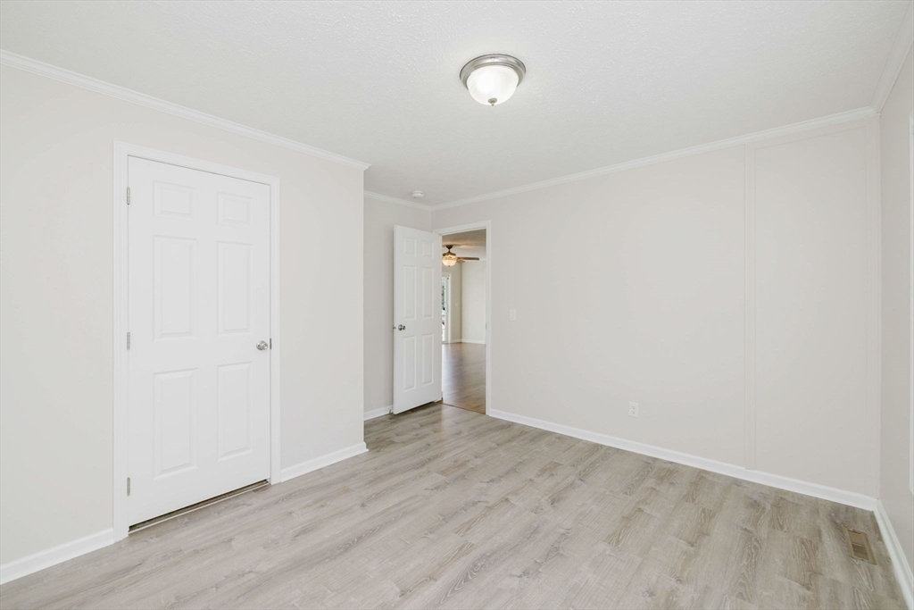 17 Maries Way Raynham, MA 02767 - Photo 27 of 39 an empty room with wooden floor and windows