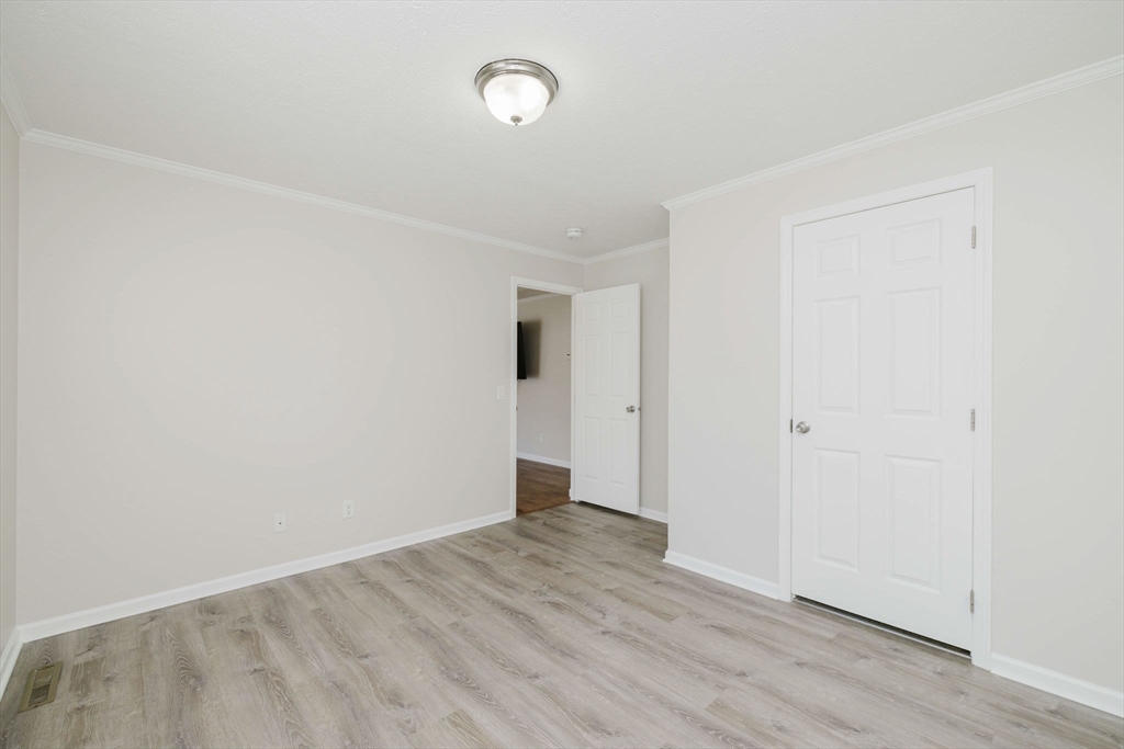 17 Maries Way Raynham, MA 02767 - Photo 30 of 39 an empty room with wooden floor and windows