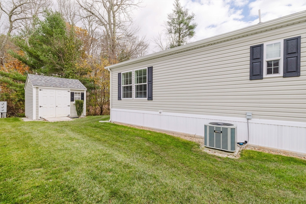 17 Maries Way Raynham, MA 02767 - Photo 32 of 39 a backyard of a house with table and chairs