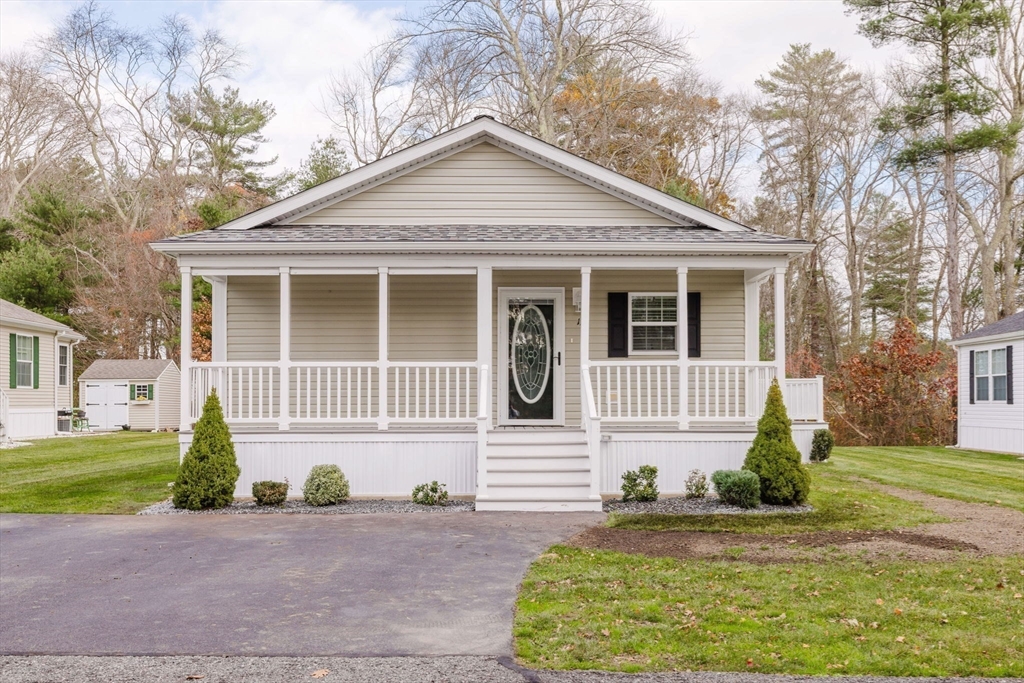17 Maries Way Raynham, MA 02767 - Photo 38 of 39 a front view of a house with a yard and garage