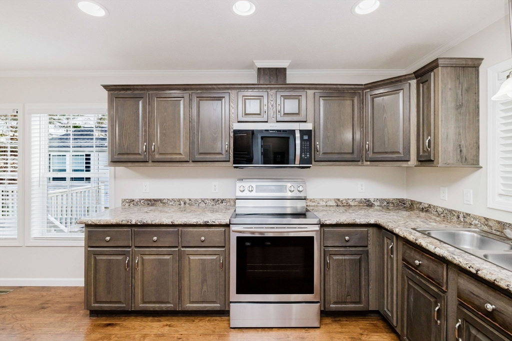 17 Maries Way Raynham, MA 02767 - Photo 5 of 39 a kitchen with stainless steel appliances granite countertop a stove a microwave and a sink