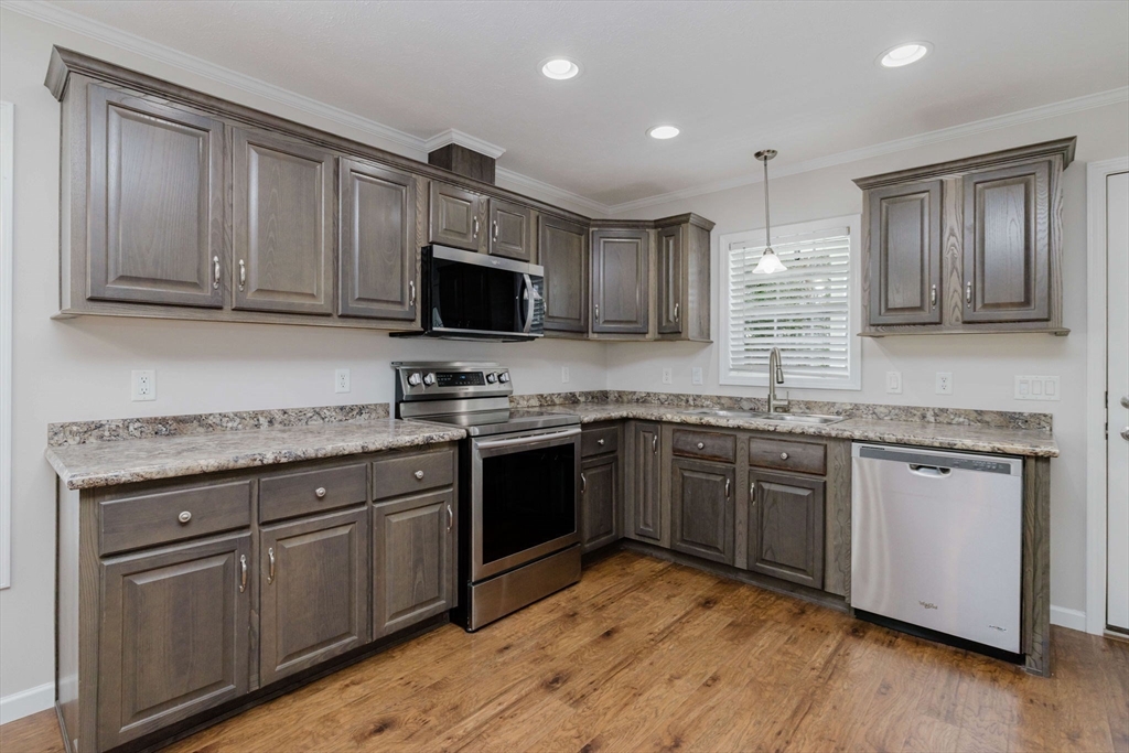 17 Maries Way Raynham, MA 02767 - Photo 6 of 39 a kitchen with granite countertop wooden cabinets and a granite counter tops