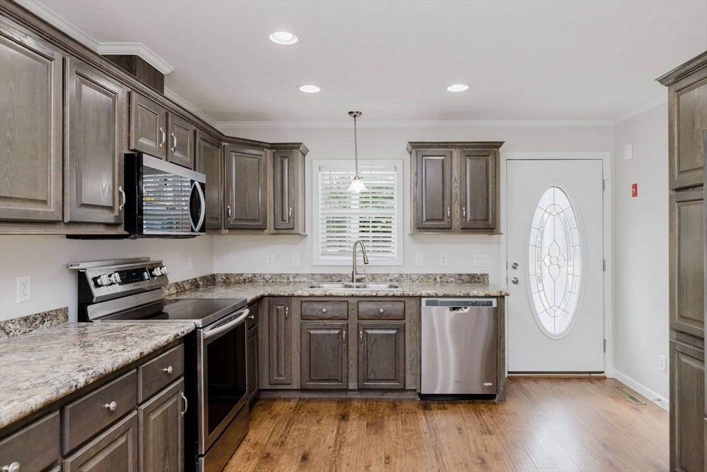 17 Maries Way Raynham, MA 02767 - Photo 7 of 39 a kitchen with stainless steel appliances granite countertop wooden cabinets a sink a stove a refrigerator and dishwasher with wooden floor