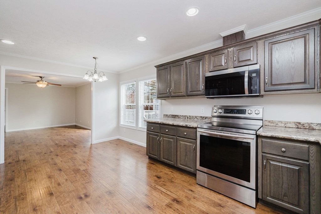 17 Maries Way Raynham, MA 02767 - Photo 8 of 39 a kitchen with stainless steel appliances granite countertop a stove microwave and sink
