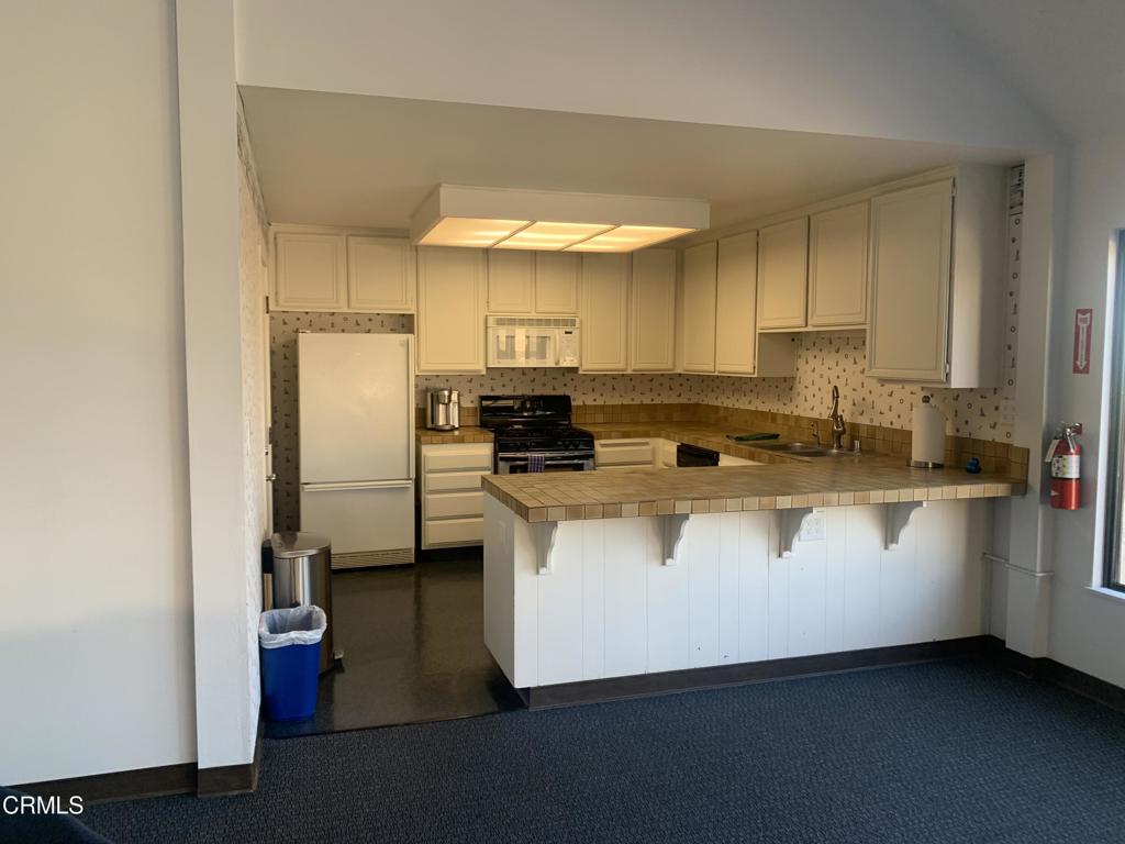 754 Island View Circle Port Hueneme, CA 93041 - Photo 62 of 67 a kitchen with stainless steel appliances a refrigerator a sink a stove and white cabinets