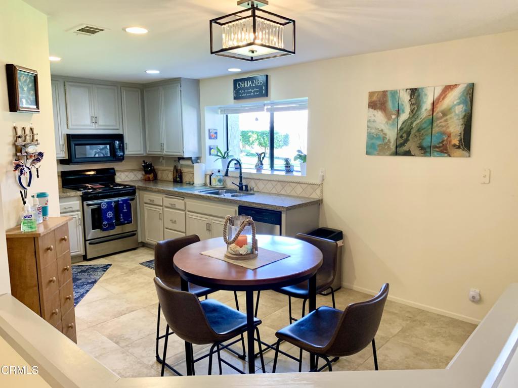 754 Island View Circle Port Hueneme, CA 93041 - Photo 7 of 67 a kitchen with stainless steel appliances a dining table and chairs