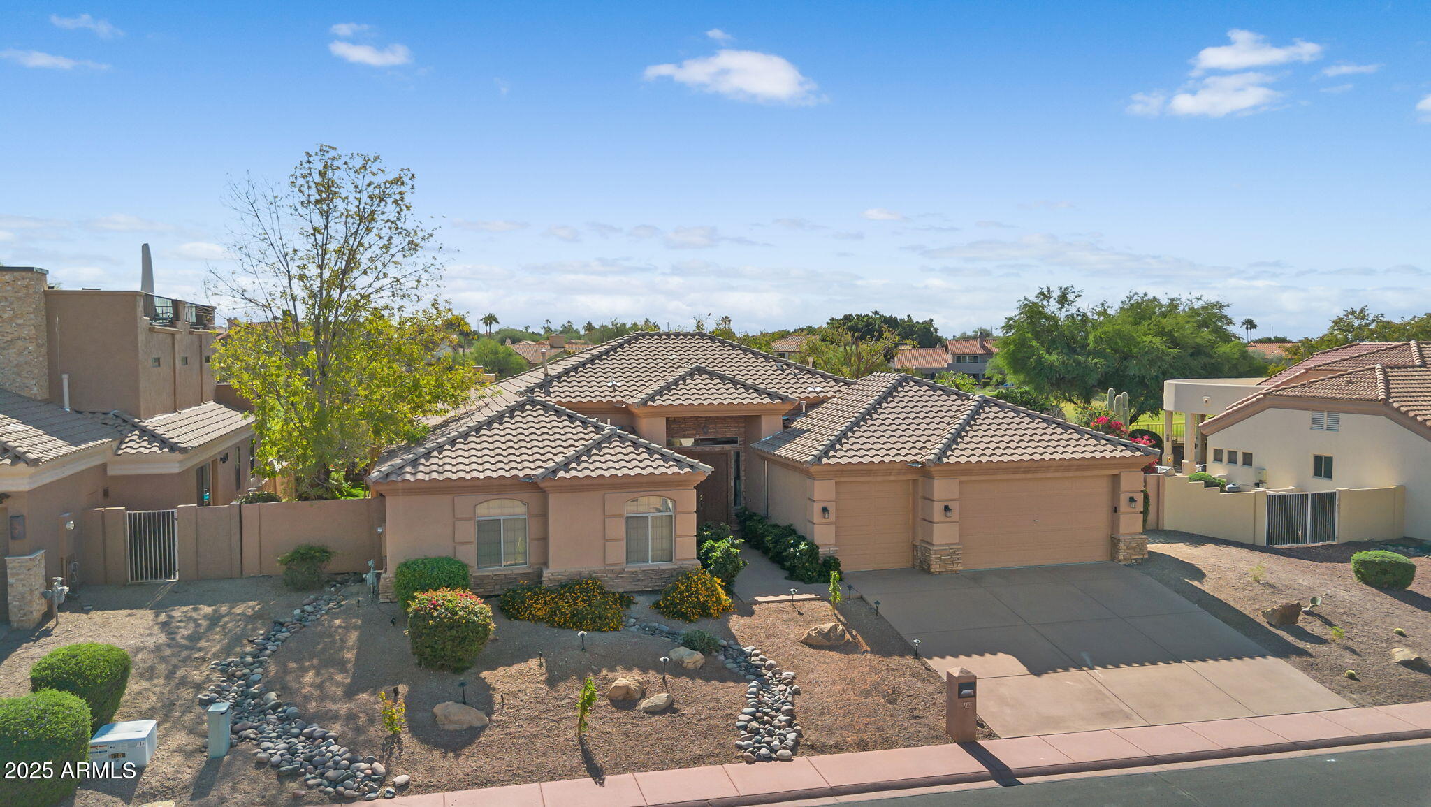 4055 North Recker Road, Unit 18 Mesa, AZ 85215 - Photo 37 of 63 a aerial view of a house with a yard and potted plants