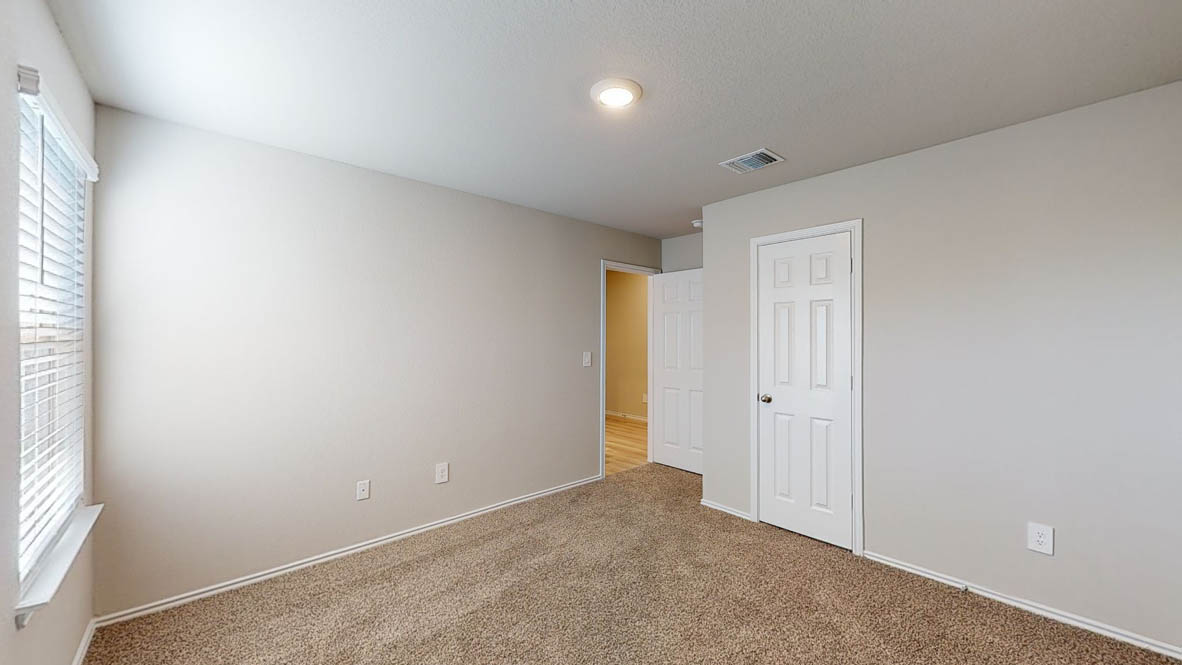 575 Hector Loop Georgetown, TX 78626 - Photo 22 of 28 Spacious interior room featuring neutral wall tones, plush carpet flooring, a window with horizontal blinds, a ceiling-mounted light fixture, and white paneled doors