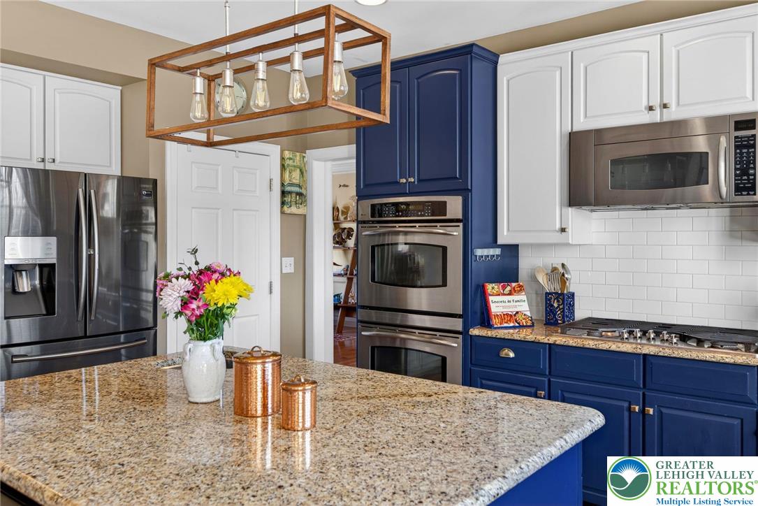 591 Rockbridge Road Nazareth, PA 18064 - Photo 11 of 73 a kitchen with stainless steel appliances kitchen island granite countertop a refrigerator oven a stove top oven and a sink