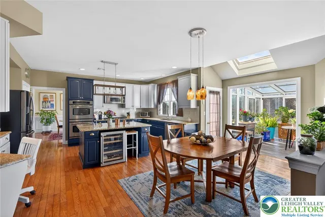 a kitchen with stainless steel appliances kitchen island granite countertop a refrigerator oven a stove top oven and a sink