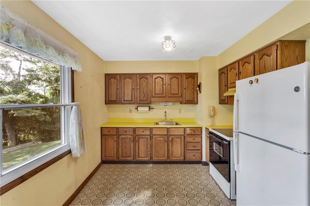 617 Blueberry Road Monroeville, PA 15146 - Photo 18 of 38 a kitchen with a sink refrigerator and cabinets