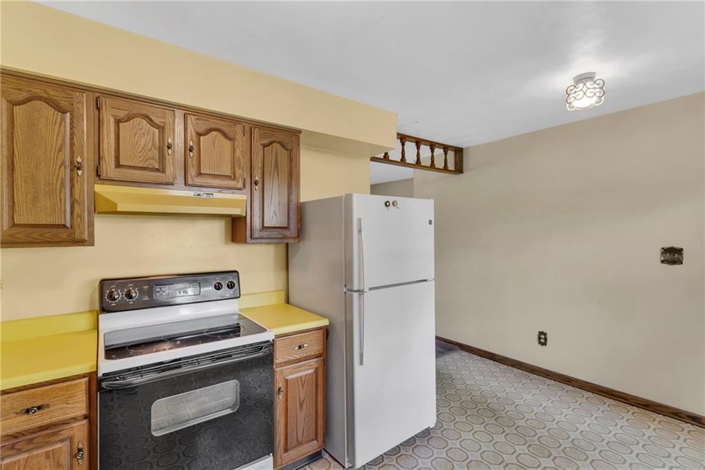 617 Blueberry Road Monroeville, PA 15146 - Photo 19 of 38 a kitchen with granite countertop a refrigerator a stove a sink and dishwasher