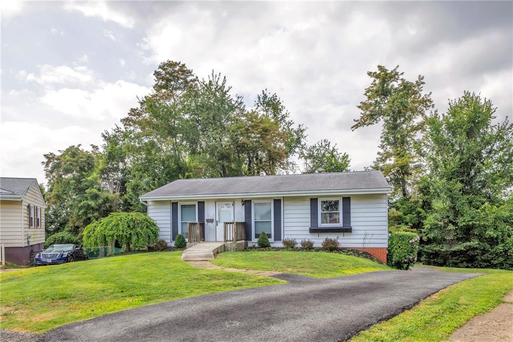 617 Blueberry Road Monroeville, PA 15146 - Photo 3 of 38 a front view of a house with a garden and trees
