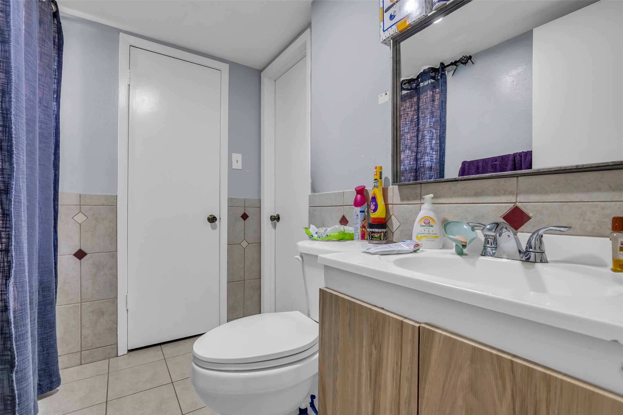 8823 Rutherford Lane Houston, TX 77088 - Photo 11 of 19 a bathroom with a sink a toilet and a mirror