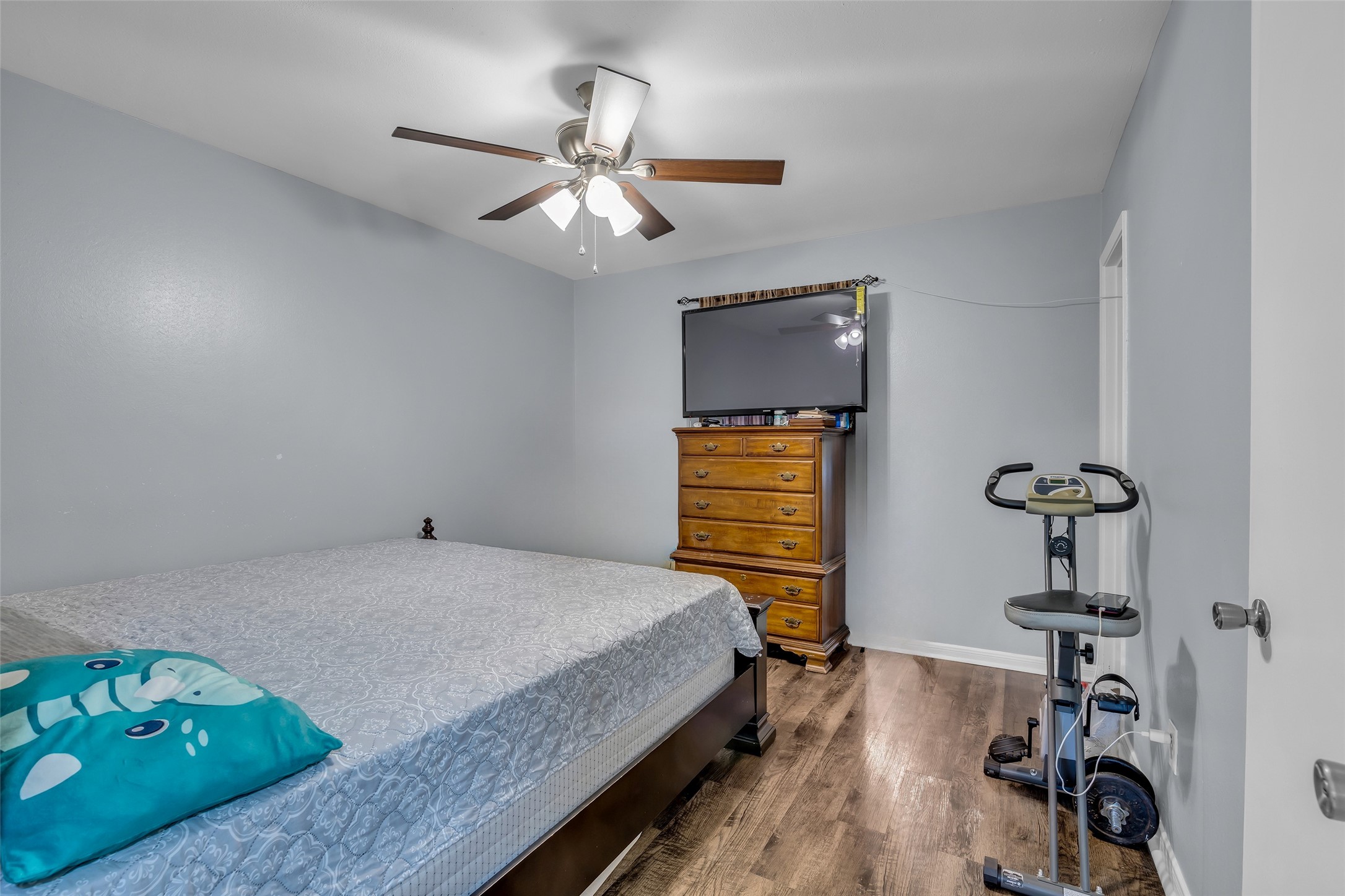 8823 Rutherford Lane Houston, TX 77088 - Photo 13 of 19 a bedroom with a bed and a chandelier