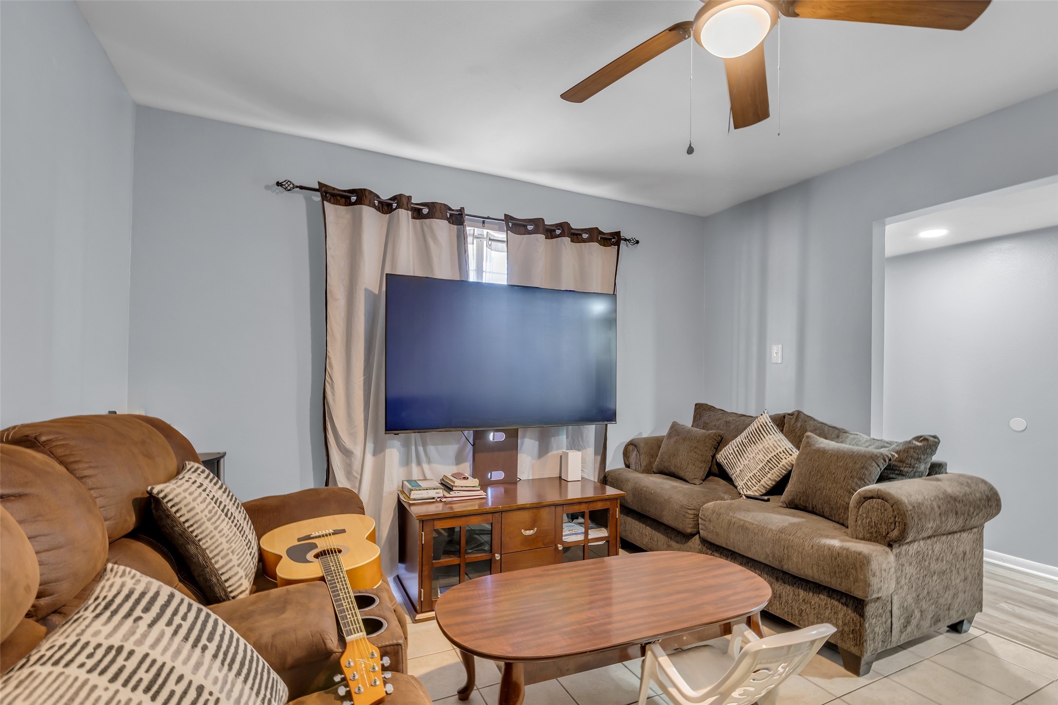 8823 Rutherford Lane Houston, TX 77088 - Photo 3 of 19 a living room with furniture and a flat screen tv