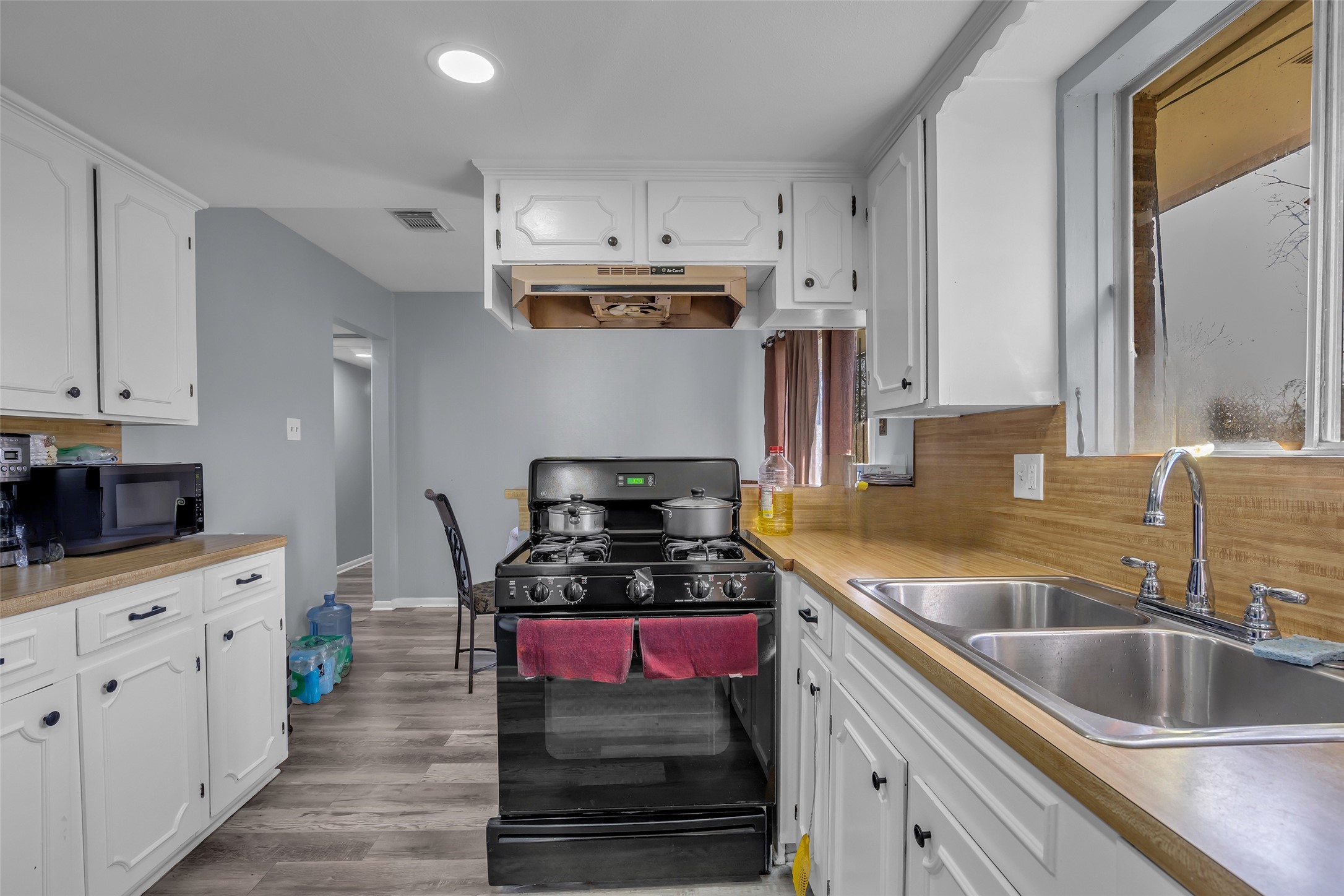 8823 Rutherford Lane Houston, TX 77088 - Photo 8 of 19 a kitchen with stainless steel appliances kitchen island granite countertop a sink stove and cabinets