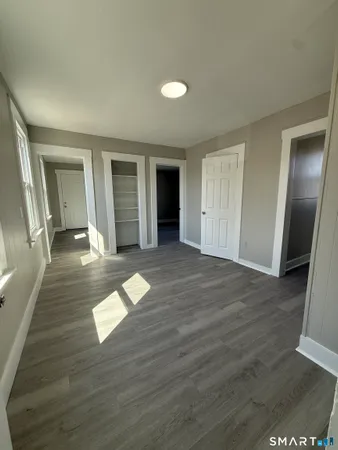 wooden floor in a hall with an empty room